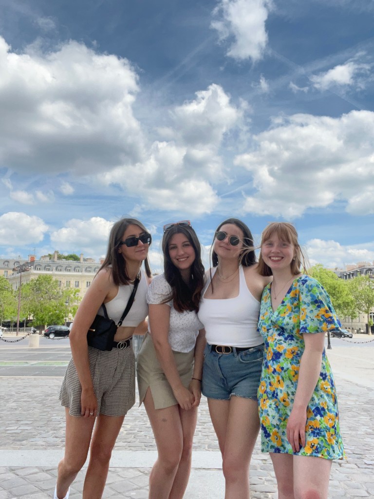 four girls posing for a photo together, all smiling