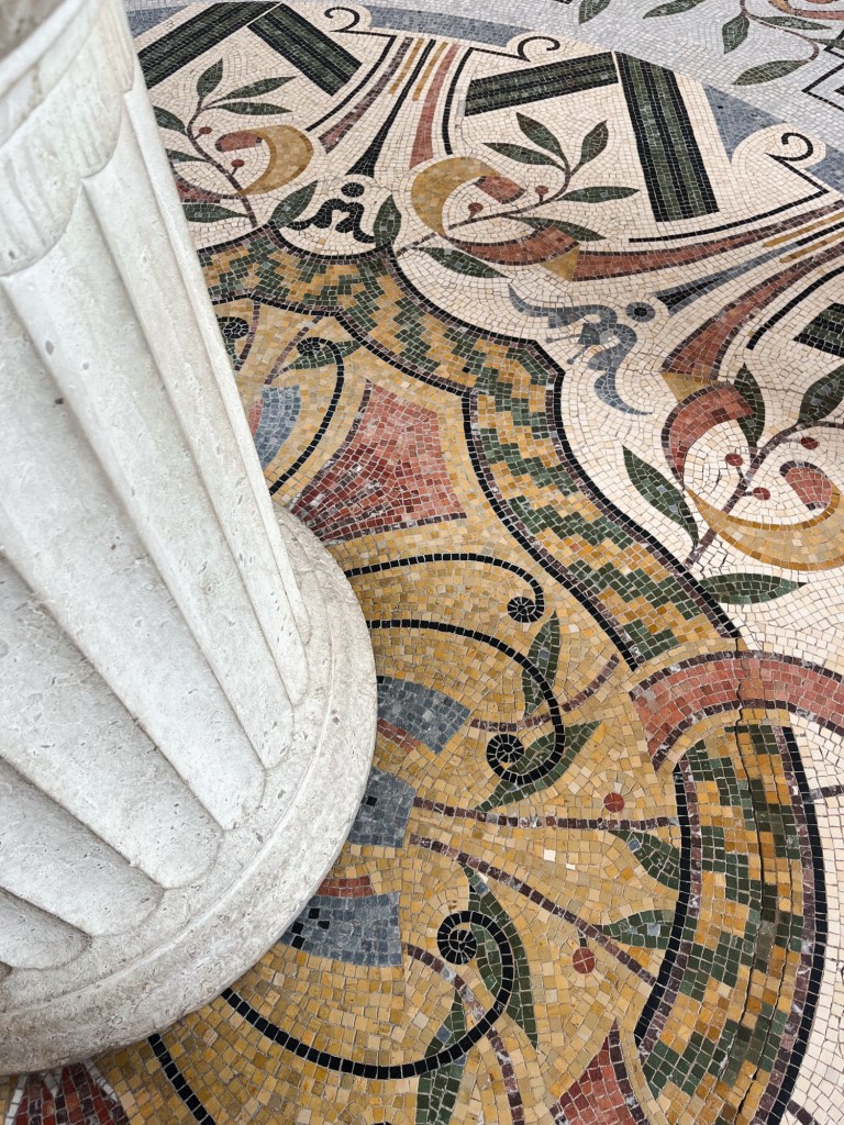 an intricate mosaic of tiles in green, yellow and red