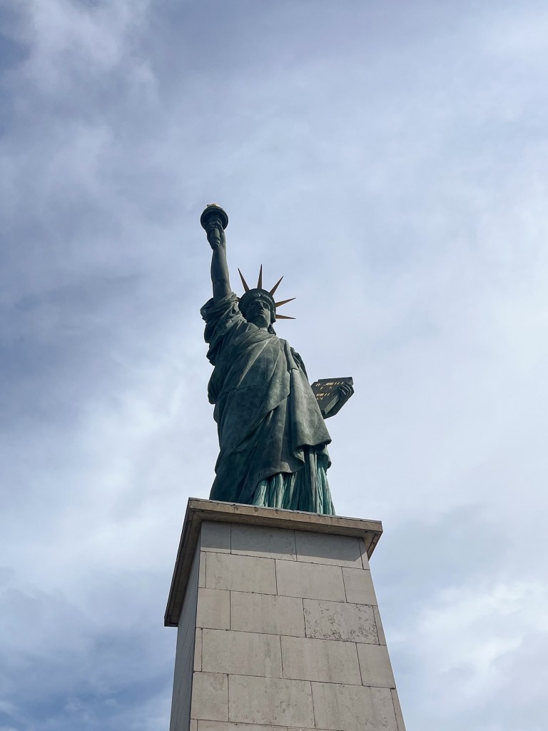 The statue of Liberty in Paris against a blue sky
