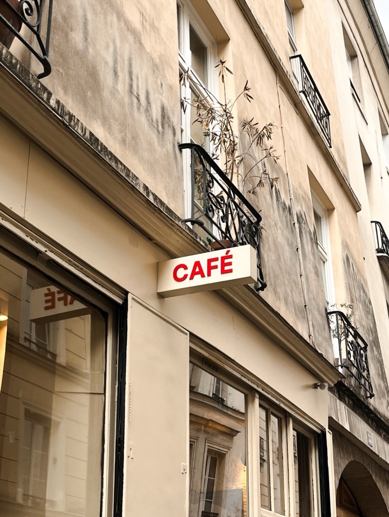 a sign saying, "cafe," in a bold red font 