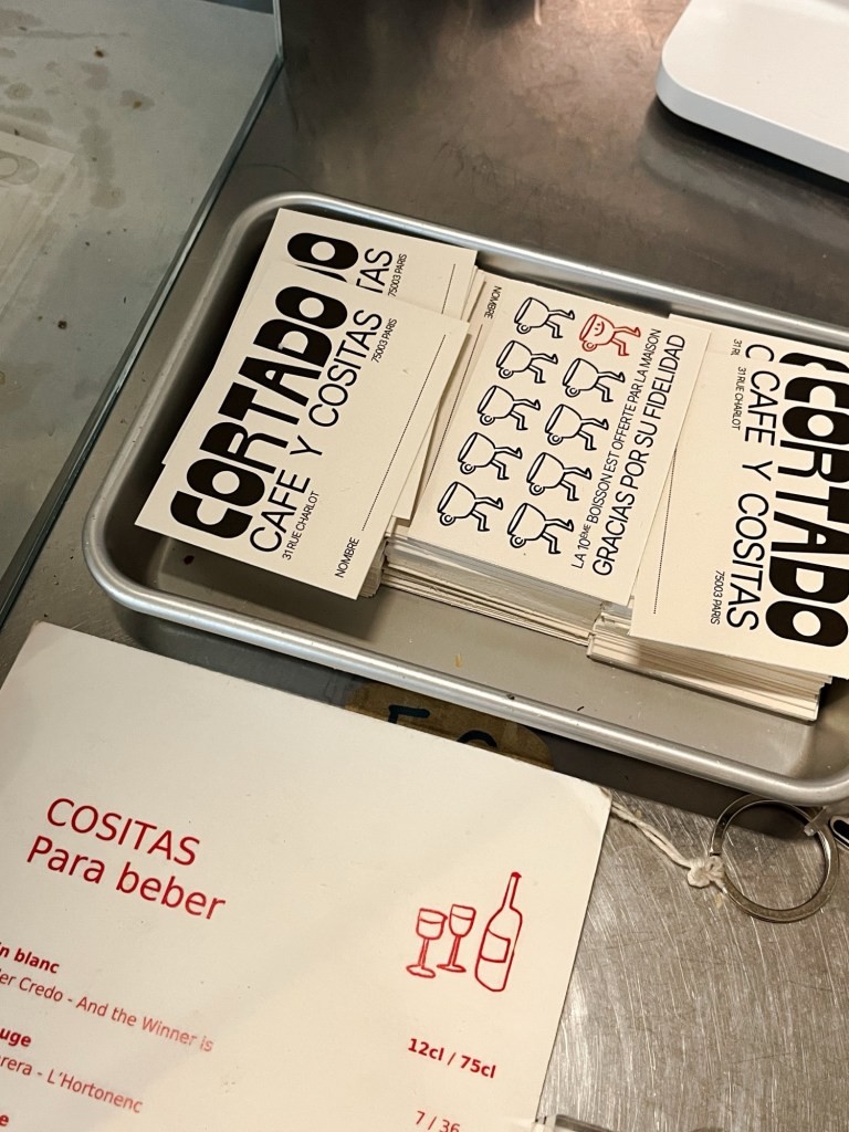 some loyalty cards for a coffee shop stacked next to the till.