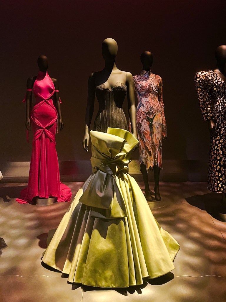 a corseted dress with a mermaid train designed to look like ribbon