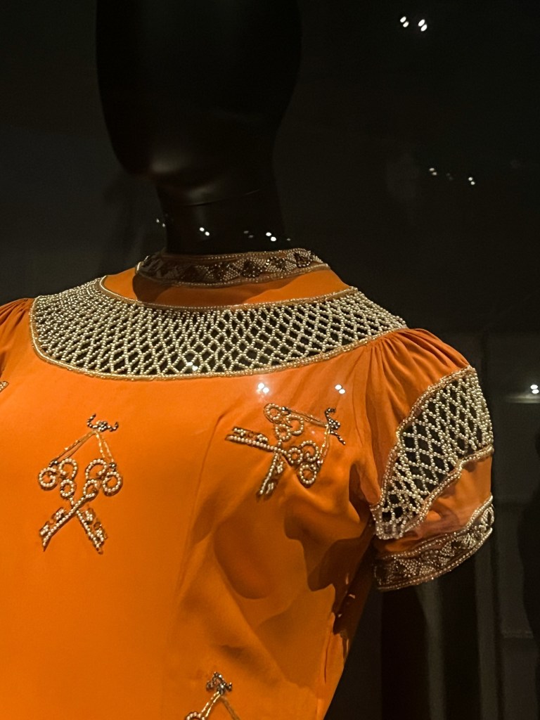 A tangerine orange dress with beaded embroidery