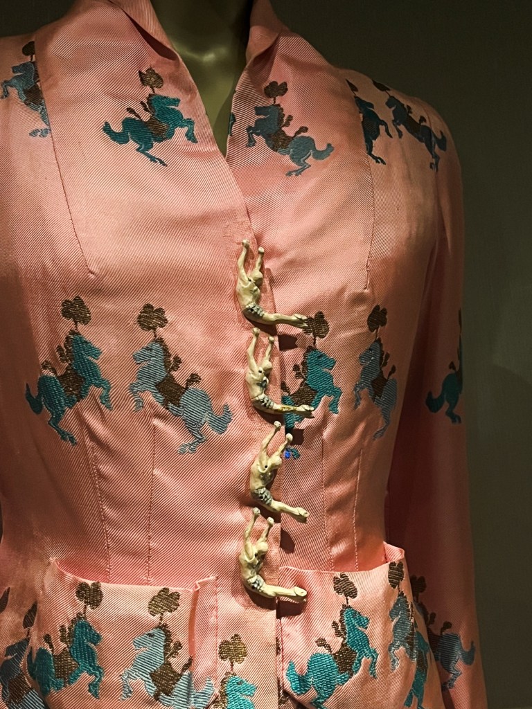 a pink jacket with acrobatic buttons